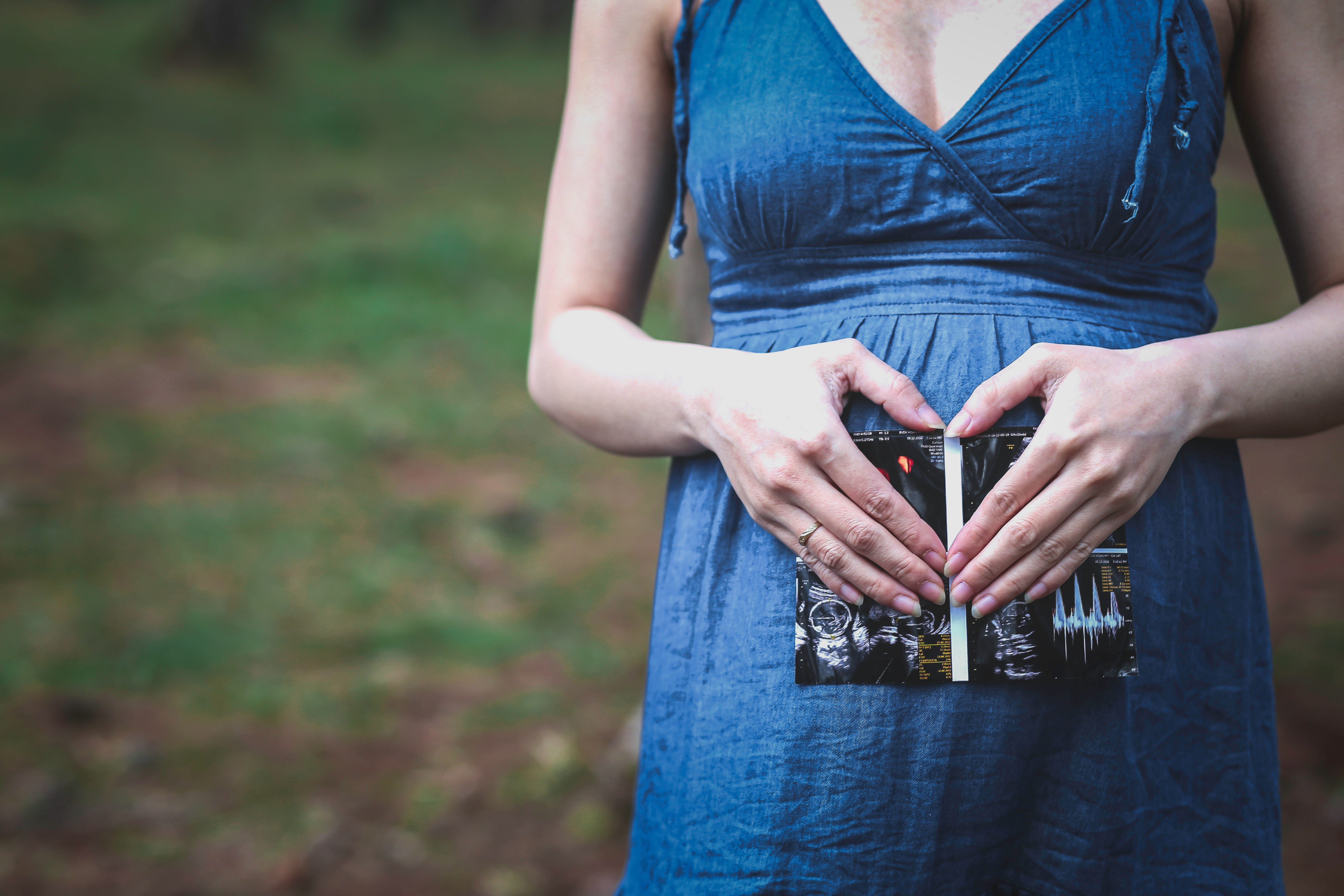 pregnant woman holding her tummy